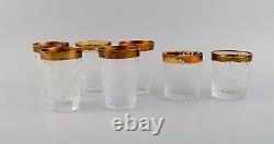 Seven drinking glasses in mouth-blown crystal glass with gold edge. France 1930s
